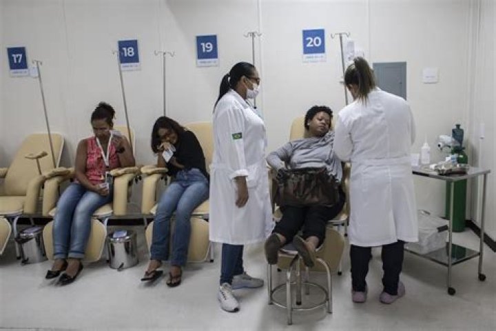 Brazil’s health agents scour junkyards and roofs for mosquitos to fight dengue epidemic