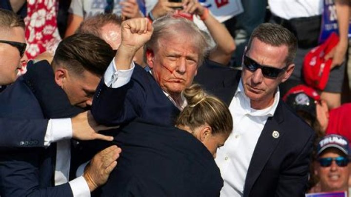 Donald Trump supporter is knocked unconscious by 'Muslim ban' protester
