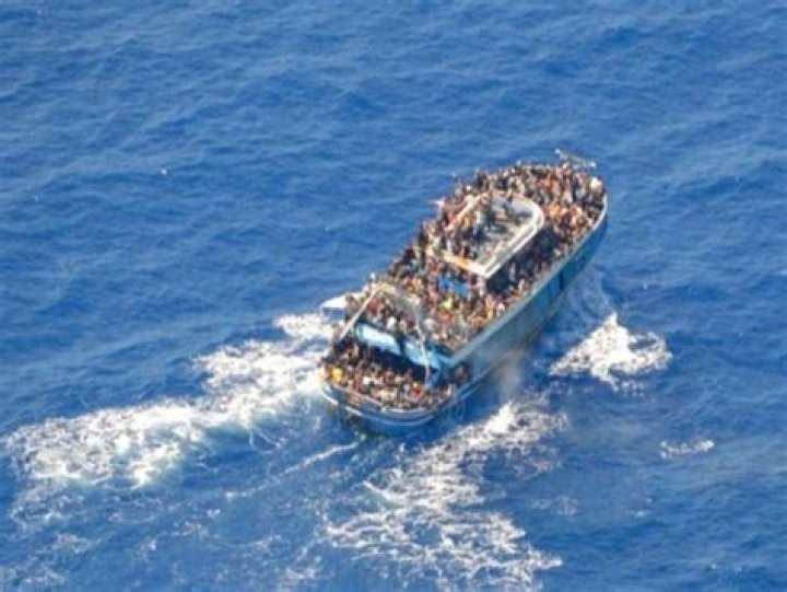 Dozens saved by Italy from migrant shipwrecks; some, clinging to rocks, plucked to safety by copters
