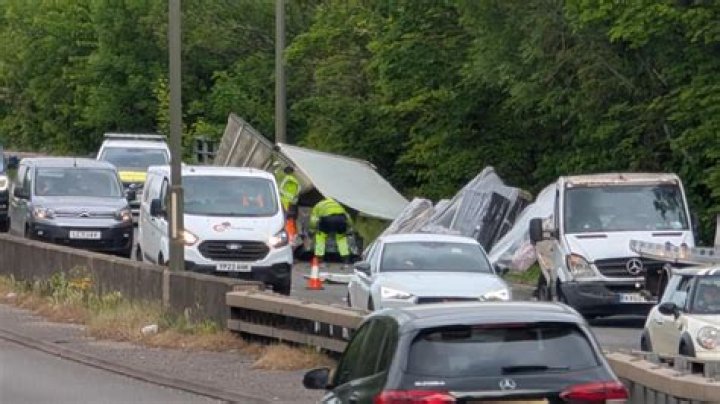 Two people taken to hospital after woman trapped under lorry in A52 crash